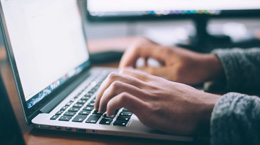 Person typing on a laptop