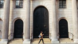 Person walking in front of a bank