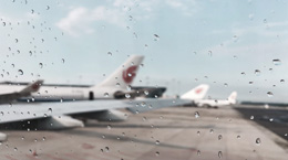 Looking out at airport over plane wing
