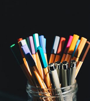 Pens in glass cup