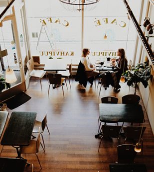 People sitting down to coffee