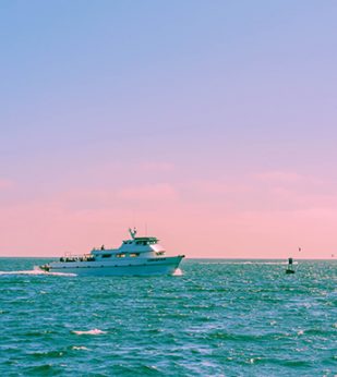 Yacht on ocean during sunset