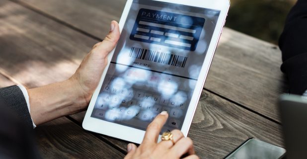 Woman filling out payment information on tablet