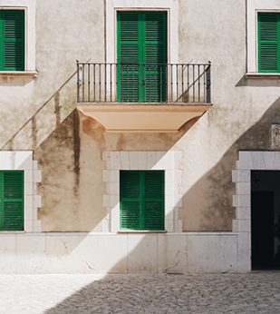 green shutters on a balcony