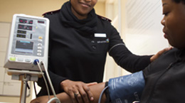 A nurse takes a patients blood pressure