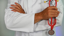 Doctor with arms crossed holding stethescope