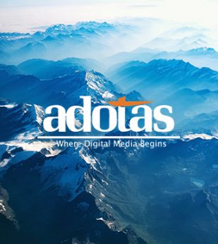 Adotas logo overtop a blue mountain range