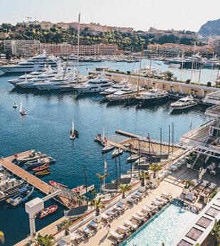 pool and lounging area overlooking yacht dock and ocean