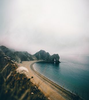 Cliffs near sandy beach next to the ocean