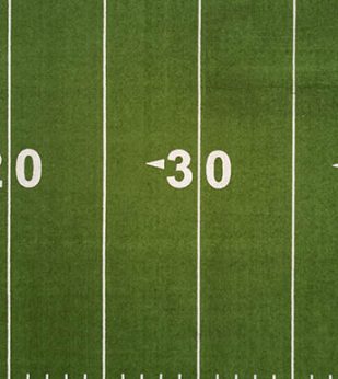 Aerial view of an American football field, showing the 20 and 30 yard lines.