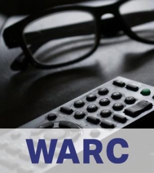 A television remote and a pair of glasses sit on a couch cushion, in black and white.. The WARC logo is below in a white band.