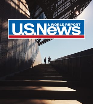 People standing near building with US News logo overlayed