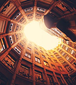 Looking up at a rounded building with windows