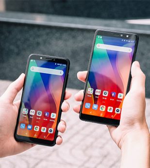 person holding two phones