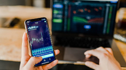 Holding phone up in front of computer