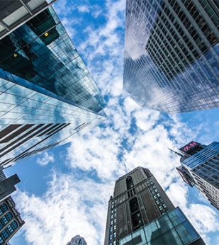 looking up at glass buildings