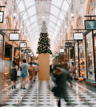 Shoppers walk around a crowded mall during the holiday season