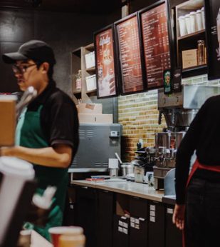 Baristas fill orders at a coffeehouse