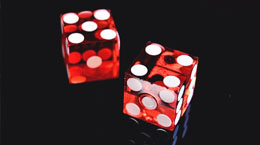 A pair of red dice on a black background