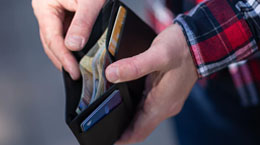 A man holds open a wallet