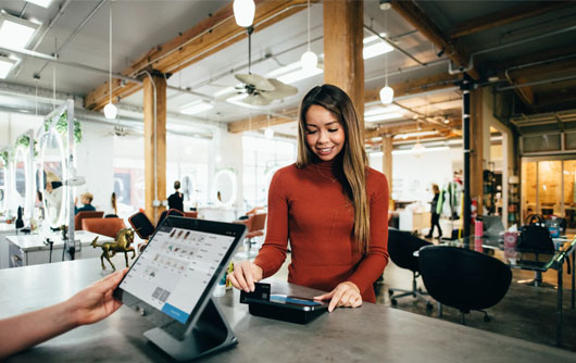 A woman pays for an order with a credit card