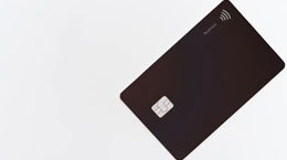A black credit card against a white backdrop
