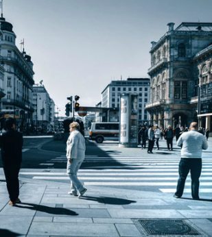 People walk around a city